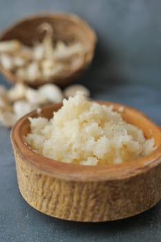 close up of minced garlic on a wooden spoon ,