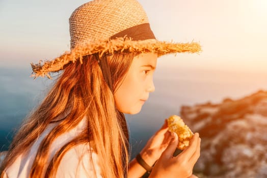 Portrait of young beautiful girl eating corn. Snacking on the sea