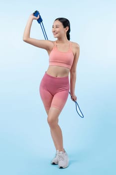 Young energetic asian woman in sportswear with jumping or skipping robe posing portrait in studio shot on isolated background. Cardio exercise tool and healthy body care lifestyle. Vigorous