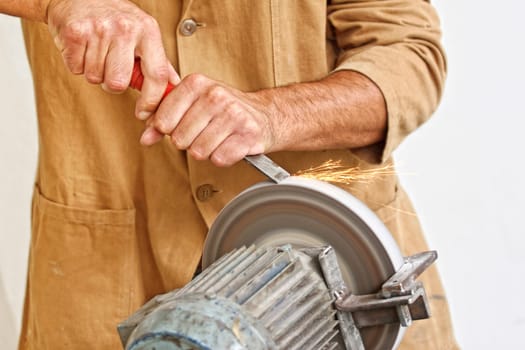 manual worker sharp his tool