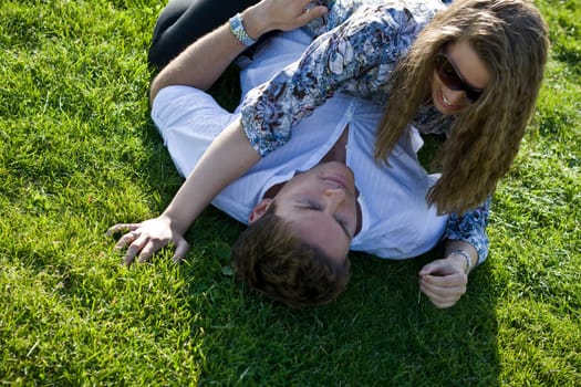 Happy Couple Playing On The Grass