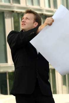architect looking at blueprint