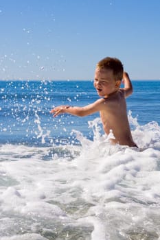 Child playing in the sea
