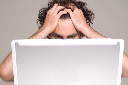 man looking at computer in desperation