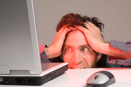 man looking at computer in desperation