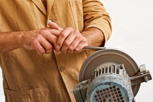 manual worker sharp his tool
