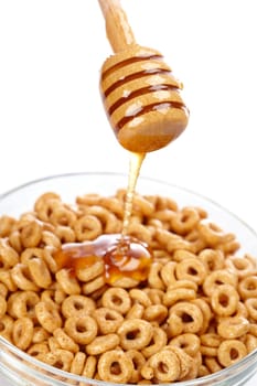Pouring honey on cornflakes
