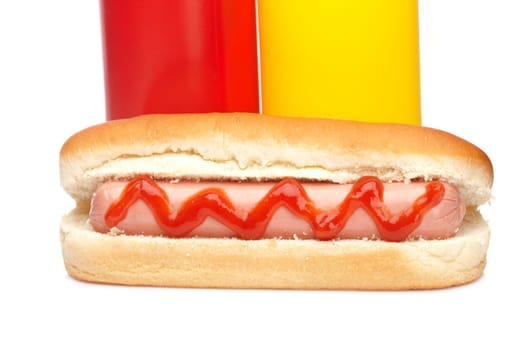 Hot dog with ketchup and mustard bottles