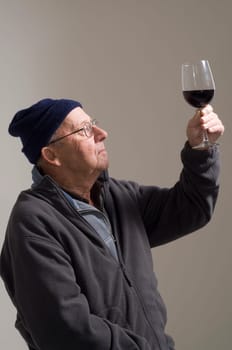 Senior man with glass of red wine