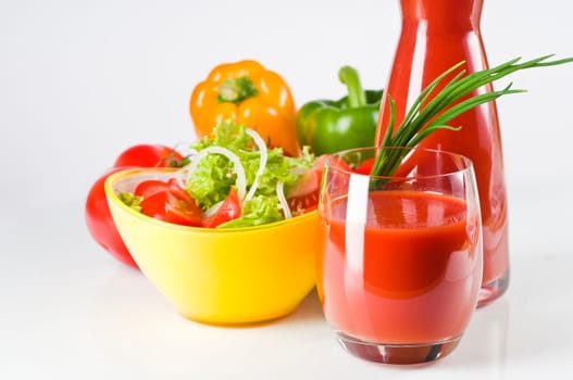 Vegetable juice in glass with colorful vegetables