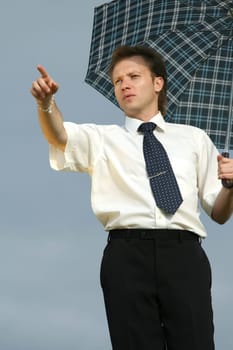 man with umbrella pointing with finger