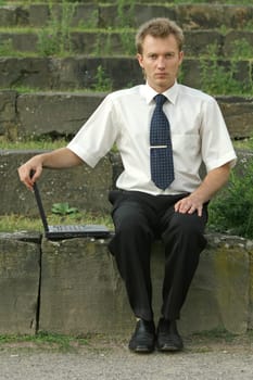 businessman with computer on the steps