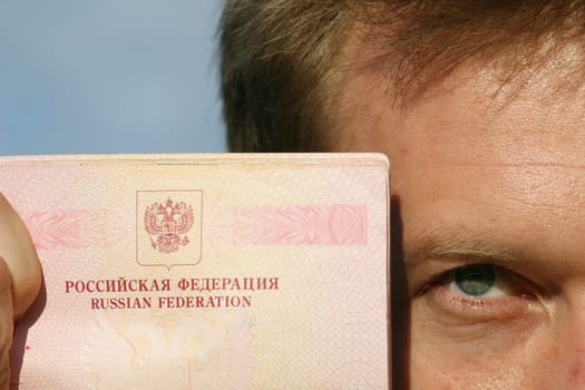 man holding russian pass