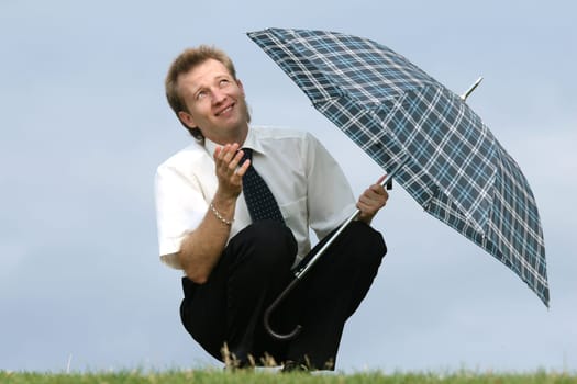 man with umbrella looking into skies
