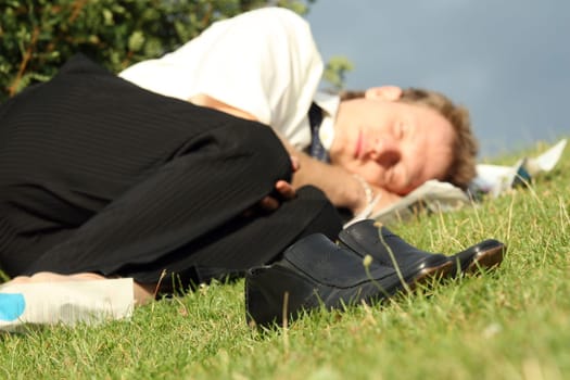 businessman sleeping in park