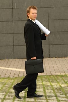 walking man with blueprints