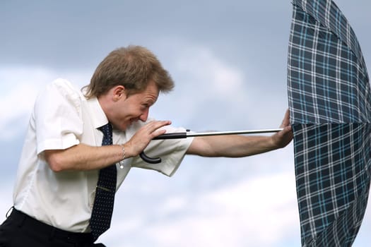pushing umbrella against wind