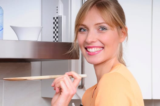 Blond woman cooking in a modern kitchen