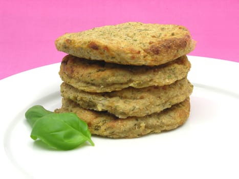 Potato patties stacked with basil