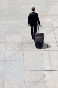 Corporate Man Leaving With Luggage