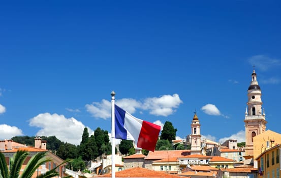 The tricolor,the French national flag,in front of a small-town backdrop,Men