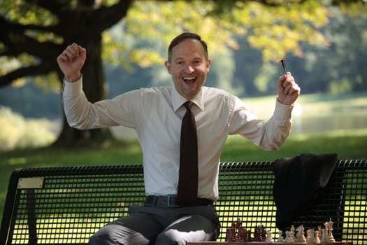 happy businessman playing chess