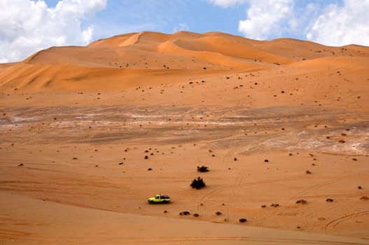 Jeep in the sand dunes of the Sahara,Libya