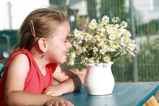 Little girl with chamomile