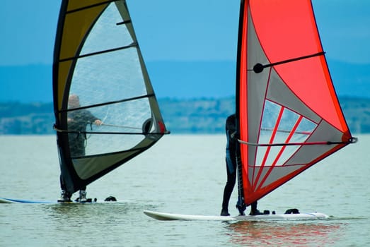 Two surfers at the lake