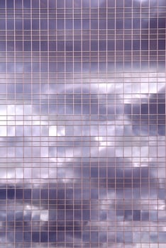 Clouds reflection in office building