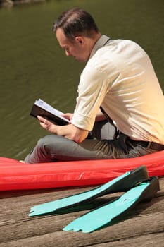 man reading his diary