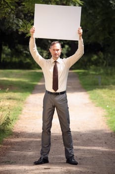 man holding blank bulletin board