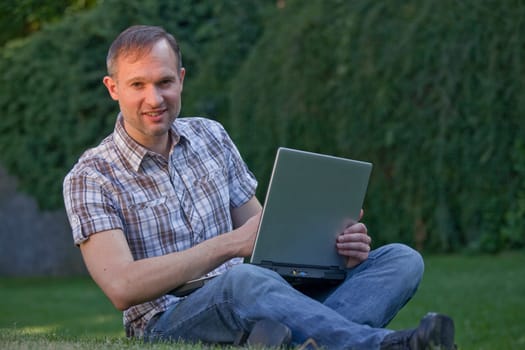 man with computer outdoor