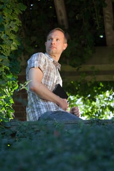 man with diary thinking