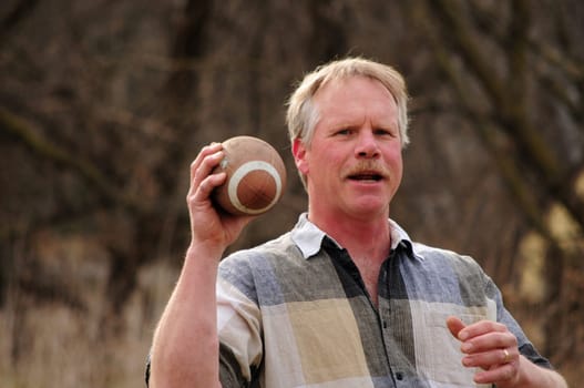 senior male holding football