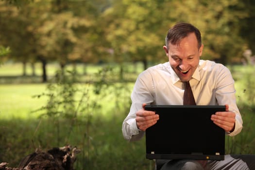 happy businessman with laptop