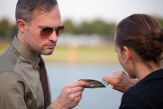 man and woman pulling on dollars