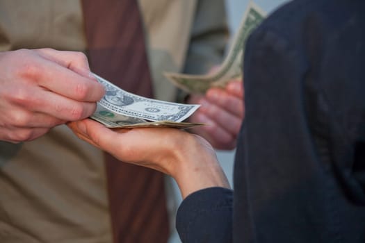 man paying with dollars