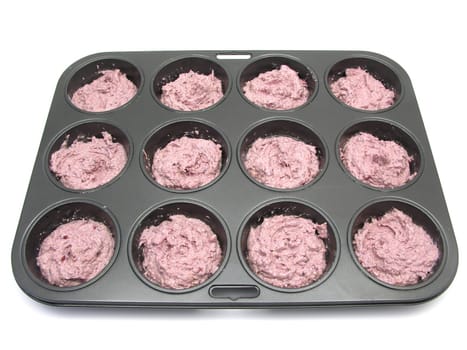Muffins in the baking pan before baking