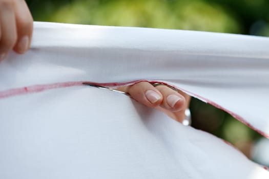 Cut open the cloth with nail scissors