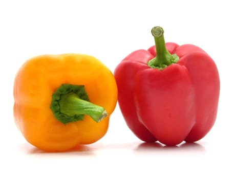 Red and yellow bell pepper against white background