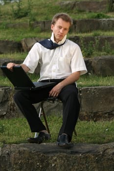 Man using laptop in park