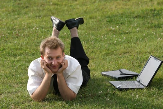 Man on the meadow with laptop