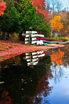 Fall forest reflections with canoes