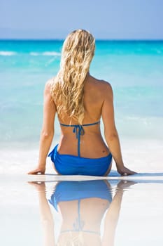 Blonde on the beach with reflection