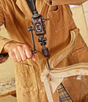 carpenter with hand drill
