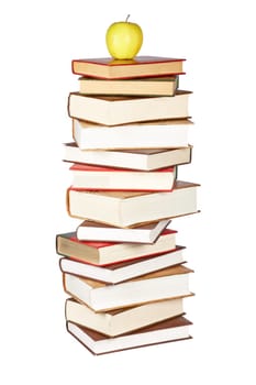 Yellow apple on pile of books
