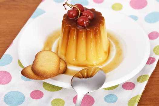 Cream caramel dessert with red currants and cookies