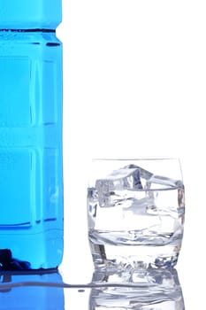 Bottle and glass of mineral water with droplets