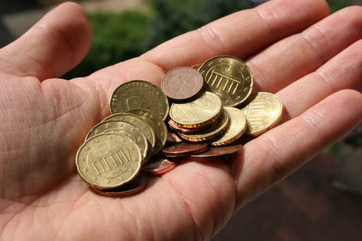 Loose change,euro coins in one hand